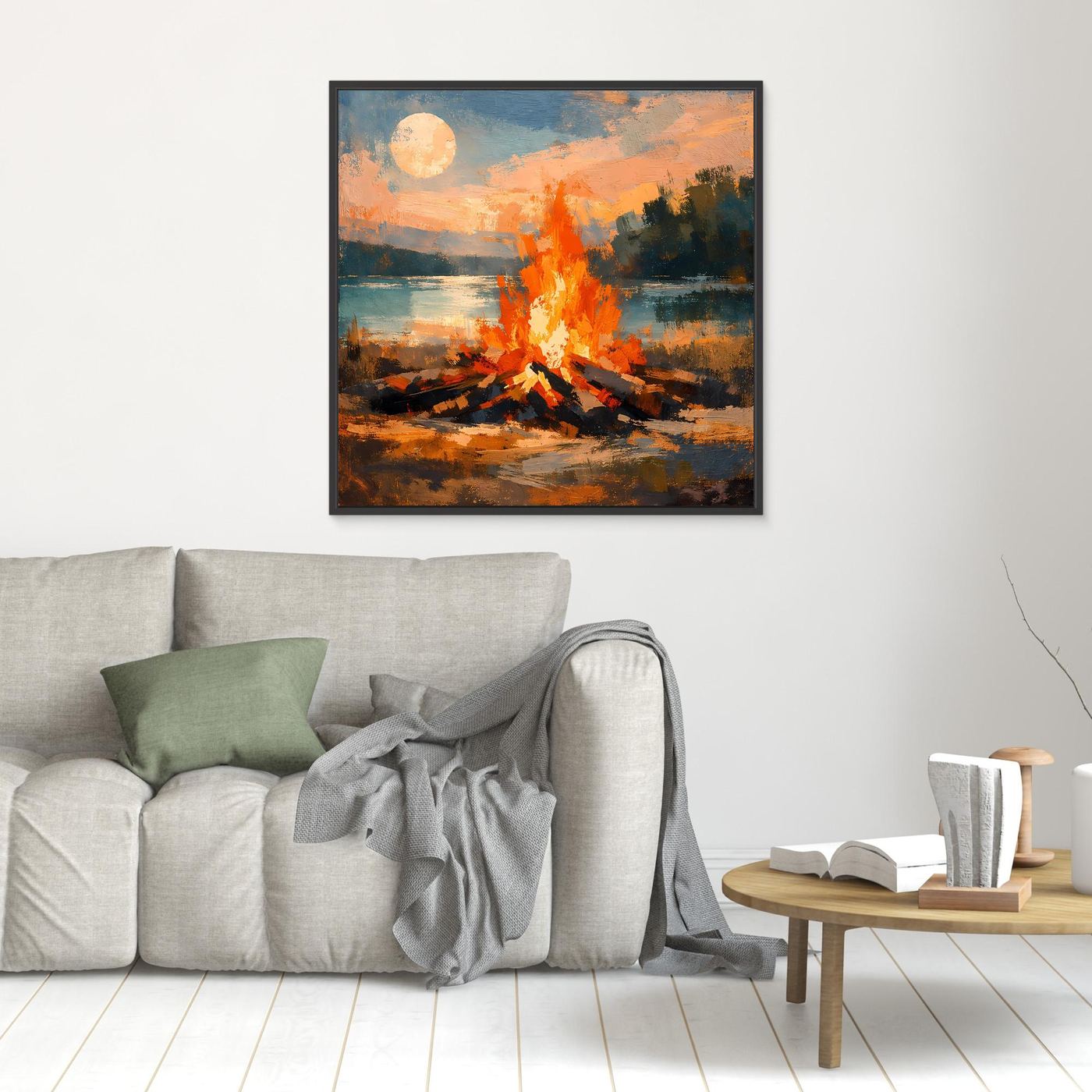 Quadratisches Wandbild mit Lagerfeuer am See, orange Flammen und runder Sonne; schwarzer Rahmen