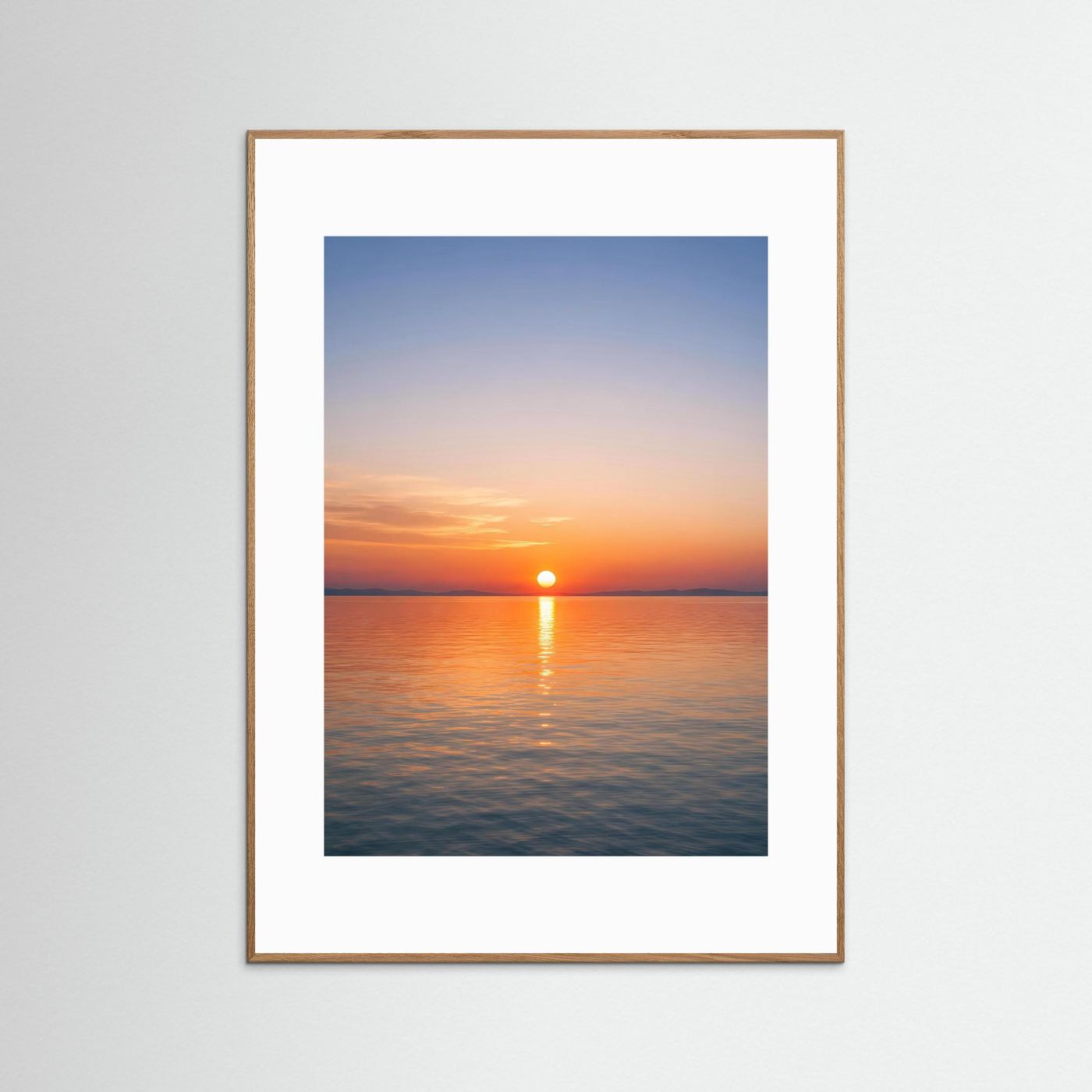 Hochformat-Wandbild: Sonnenuntergang über dem Meer, hellbrauner Holzrahmen