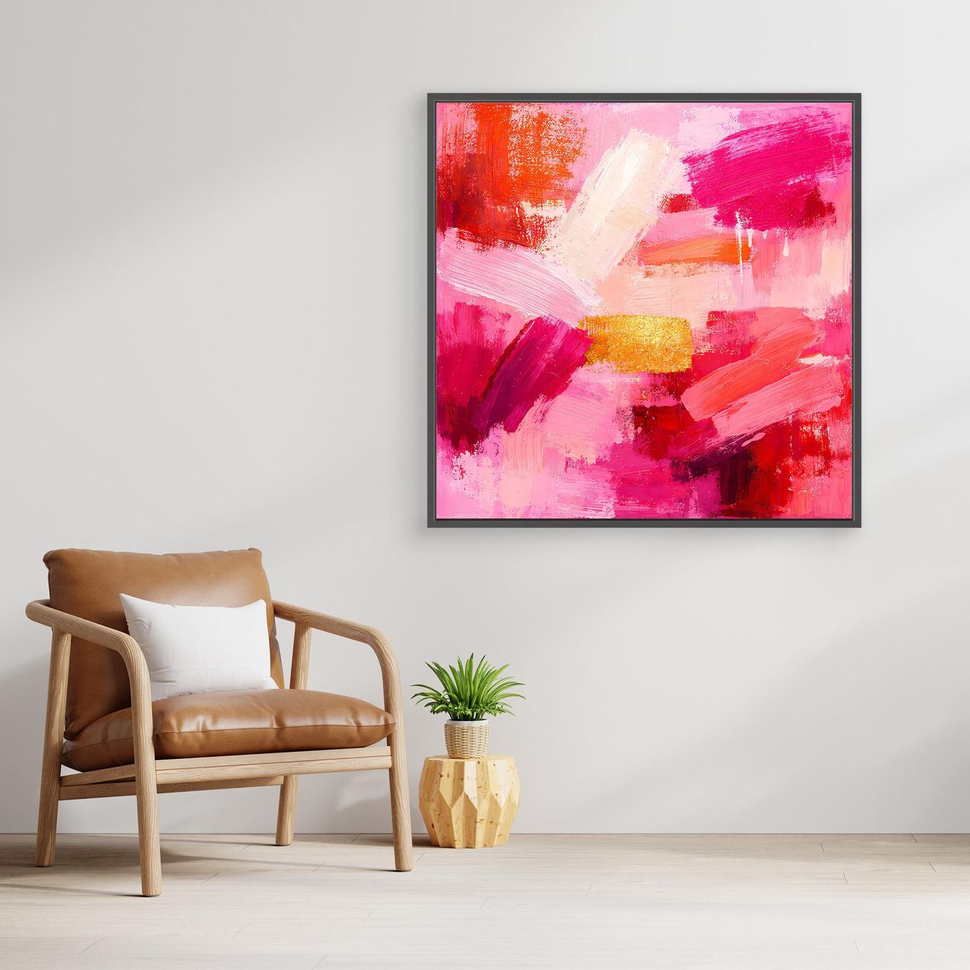 Abstract canvas wall art with pink and rose brushstrokes and small gold accents in black frame.