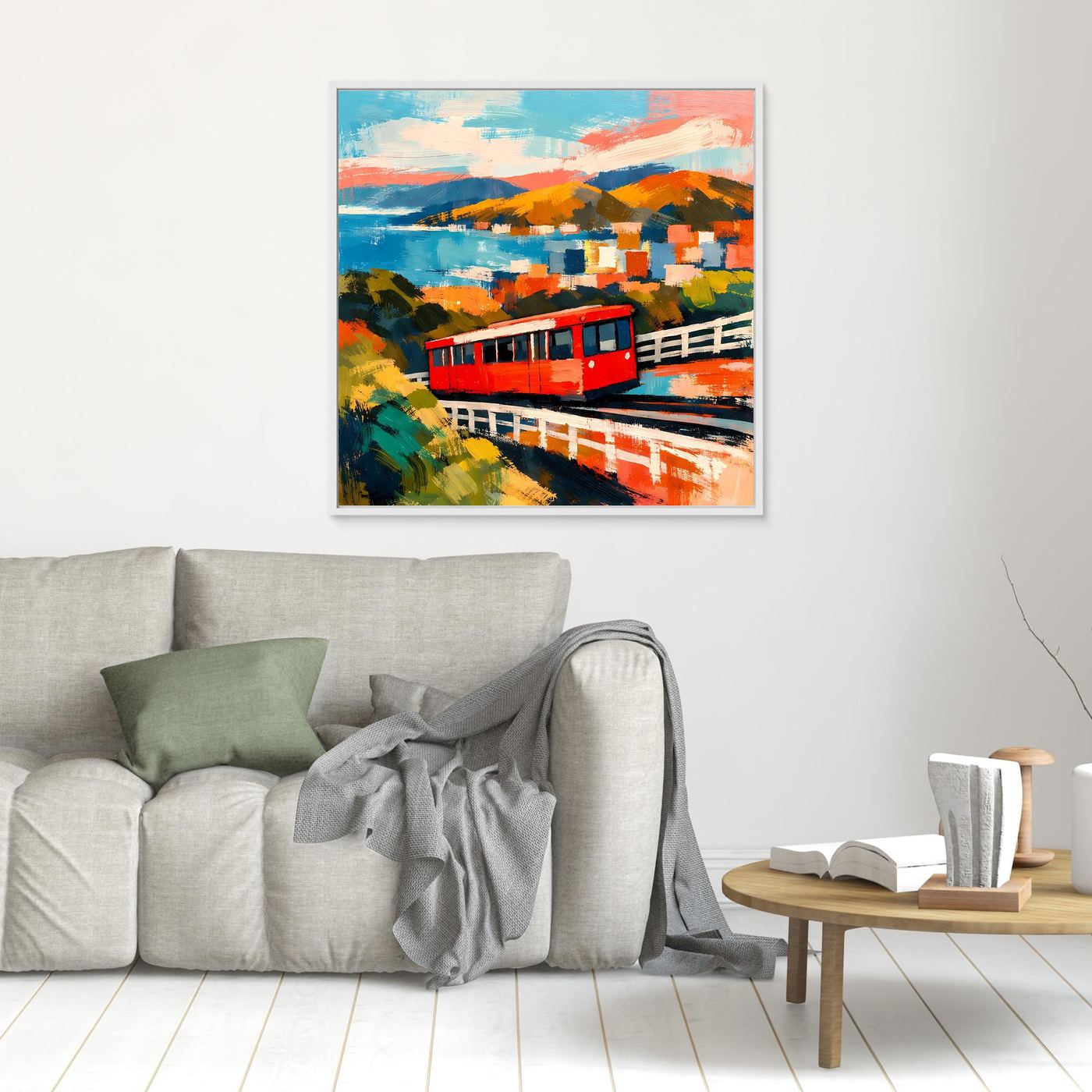Kleines Wandbild mit roter Seilbahn, farbigen Hügeln und Meer im abstrakten Stil, hell gerahmt
